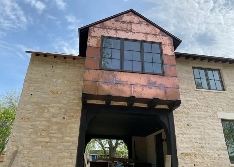 Copper metal panel facade on a stone building for Metal Roof Coating in Franklin